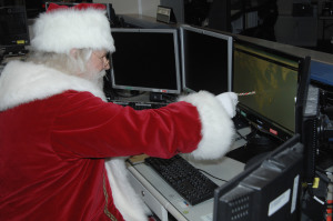 Santa reviews his flight plan at NORAD  Photo By: Michael Kucharek