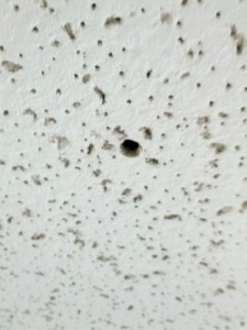 Hole in tile from a hidden camera.